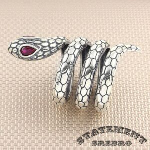 Muški prsten od 925 Srebra u obliku zmije obmotane oko prsta. Muški srebrni prsten u obliku zmije sa ljubičastim kamenjem umesto očiju. Pošto zmije menjaju kožu, simbol zmije predstavlja transformaciju i besmrtnost. Jako kreativan dizajn i kombinacija kamena sa srebrom čine da ovaj prsten izgleda neverovatno.